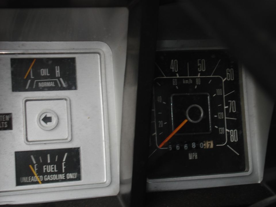 1979 Ford Bronco interior gauges showing oil pressure, fuel level, and speedometer reading 56680.7 MPH