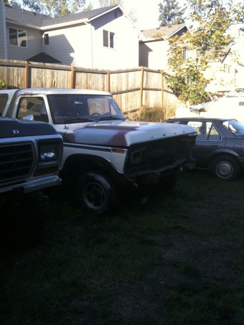 1979 Ford Bronco - This 1979 Ford Bronco is parked next to another vehicle, with its front grille and bumper removed.
