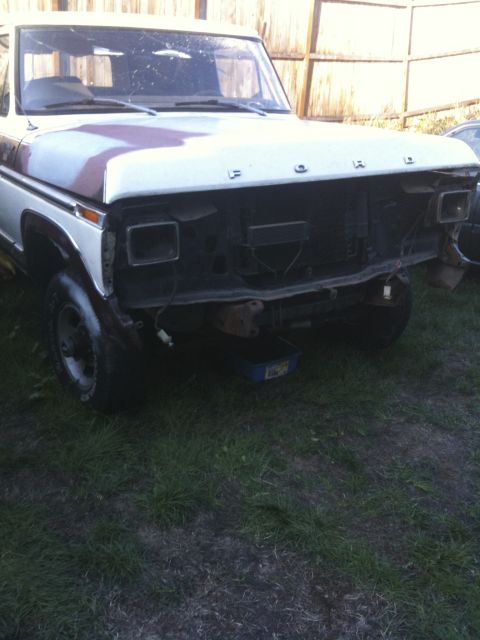 1979 Ford Bronco - Front view of a 1978 Ford Bronco undergoing repairs, grille missing.