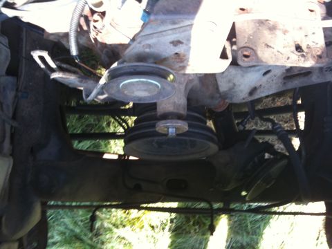 1979 Ford Bronco - Close-up of engine components, including pulleys and hoses, with visible metal brackets.
