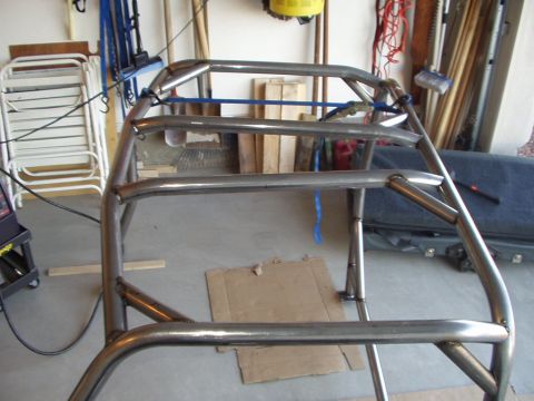 1993 Ford Bronco - A custom-fabricated roll cage is shown in a garage setting, ready for installation.