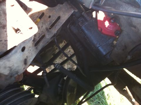 1979 Ford Bronco - Underside view of a vehicle's engine bay, focusing on the power steering pump assembly.