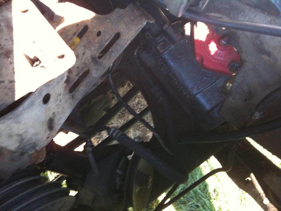 close-up of a vehicle's power steering pump and surrounding frame components