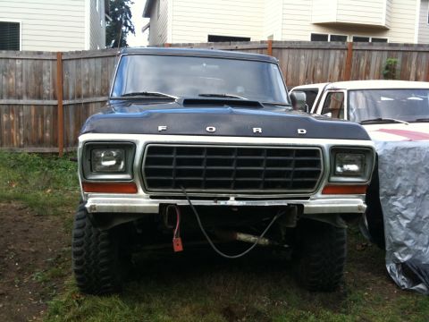 1979 Ford Bronco - Front view of a black 1979 Ford Bronco with a lifted suspension and large tires.