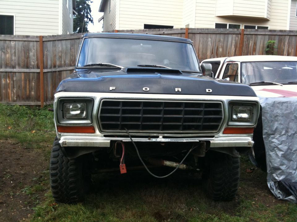 Black 1979 Ford Bronco front view, lifted with large tires, grille visible