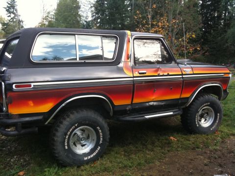 1979 Ford Bronco - This 1979 Ford Bronco features a distinctive sunset-style paint scheme and lifted suspension, giving it a appearance.