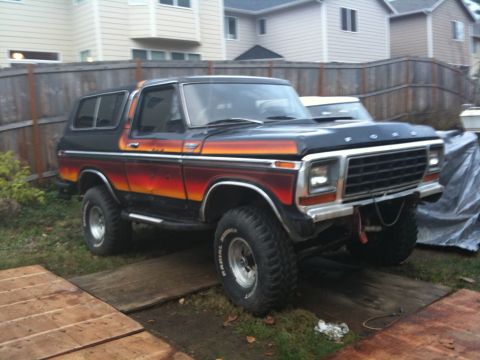 1979 Ford Bronco - This 1978 Ford Bronco features a distinctive sunset-style paint job and appears to be undergoing some work.