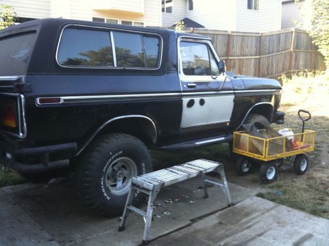 1979 Ford Bronco - This 1979 Ford Bronco features a distinctive two-tone door panel and prominent chrome accents along its side.