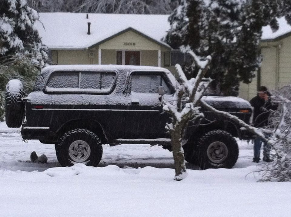 1979 Ford Bronco side view in snow with spare tire on back