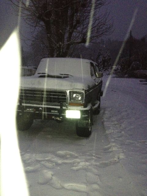 1979 Ford Bronco - A 1979 Ford Bronco sits covered in snow during a winter storm.