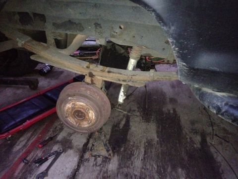 1979 Ford Bronco - Close-up of the rear suspension and axle assembly of a 1979 Ford Bronco undergoing maintenance.