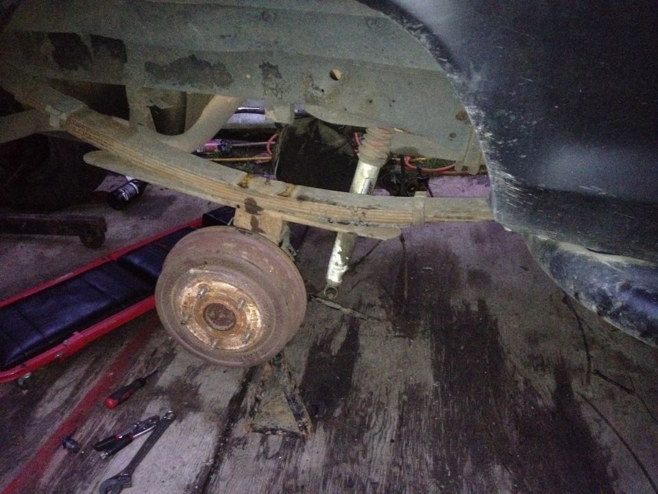 1979 Ford Bronco rear axle with leaf springs and shock absorber, drum brake visible