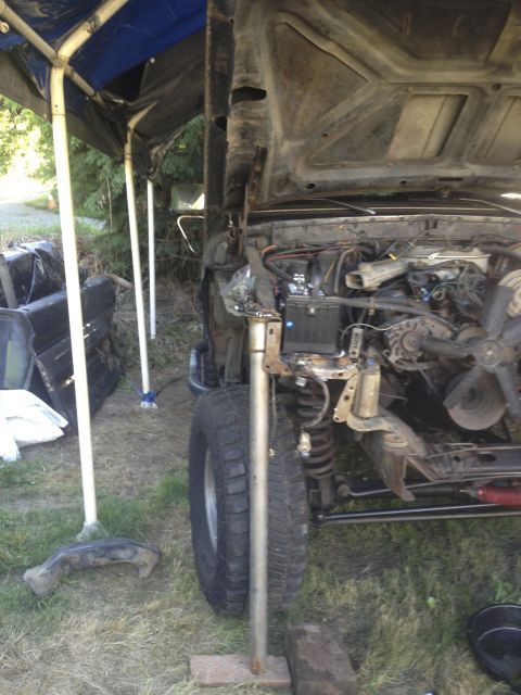 1979 Ford Bronco - Vehicle undergoing repairs or disassembly, showing the engine compartment and surrounding area.