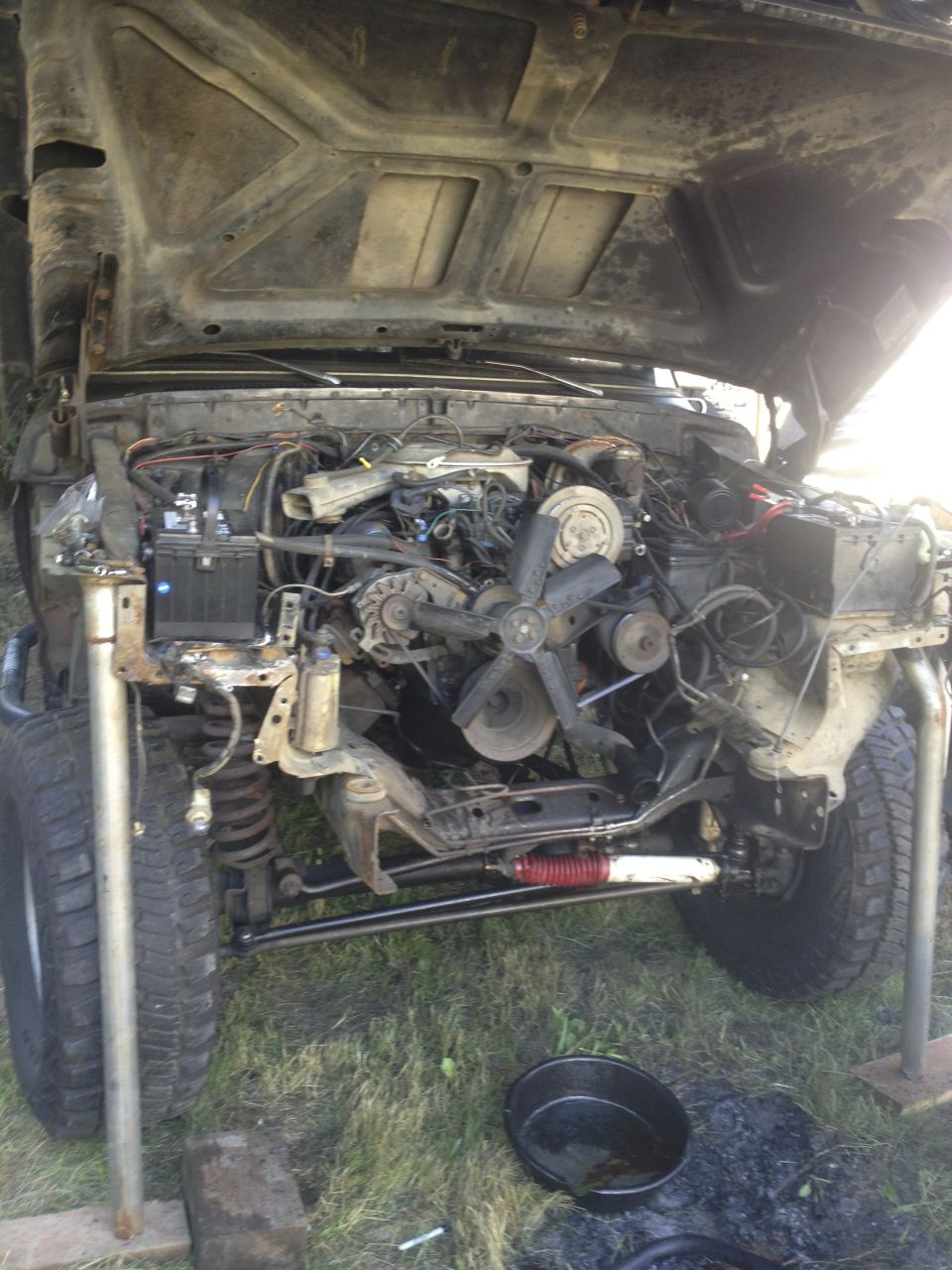 1979 Ford Bronco engine bay with hood open, front end disassembled