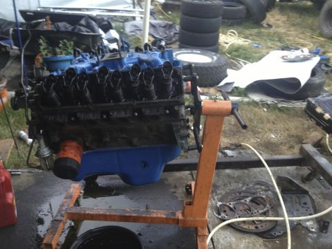 1979 Ford Bronco - An engine is mounted on an orange stand, ready for work or reassembly.