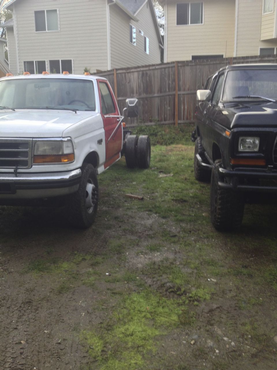1979 Ford Bronco and a newer model truck chassis parked side-by-side