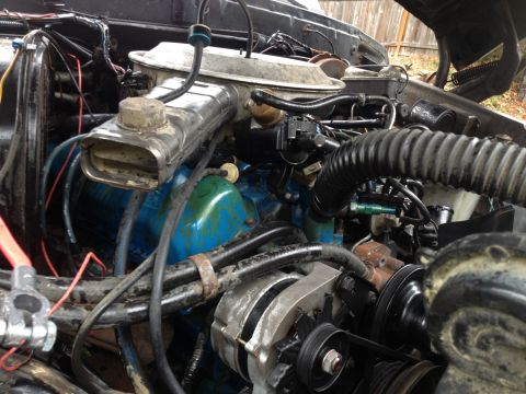 1979 Ford Bronco - Close-up view of a vehicle's engine compartment, showing various mechanical components and wiring.