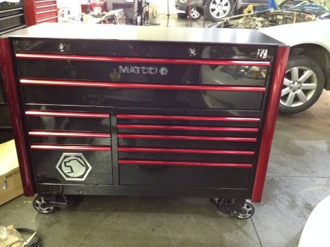 1979 Ford Bronco - A black and red Matco tool chest is in the foreground of a garage, with a car visible behind it.