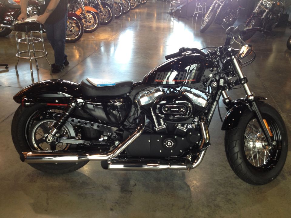 Black Harley-Davidson motorcycle side view with 'FORTY-EIGHT' on the tank
