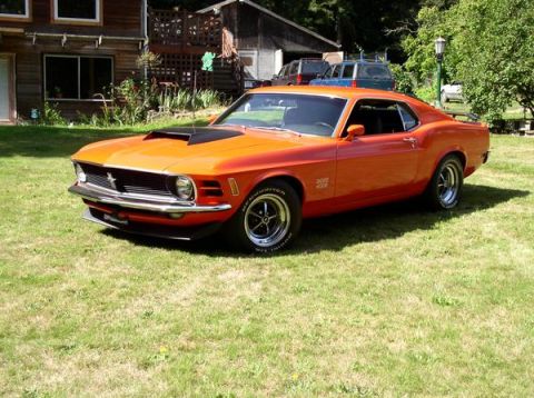 1979 Ford Bronco - This 1970 Ford Mustang Boss 429 is parked on the lawn in front of a house.