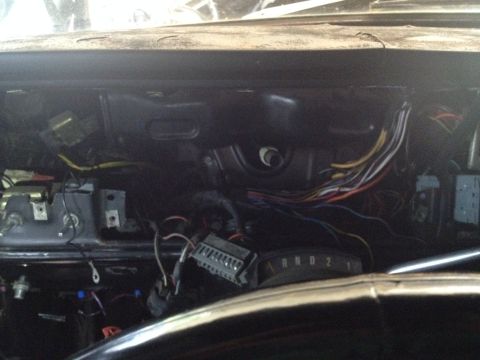 1979 Ford Bronco - The interior of a 1979 Ford Bronco reveals exposed dashboard wiring and the gear selector, suggesting a build or repair process.
