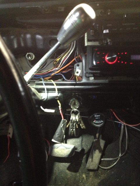 1979 Ford Bronco - Exposed wiring and aftermarket radio visible in the car's interior during a build process.