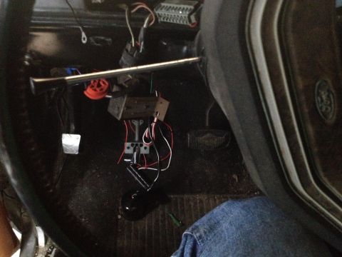 1979 Ford Bronco - Interior view of a 1979 Ford Bronco, highlighting the steering column, pedals, and exposed wiring harness.