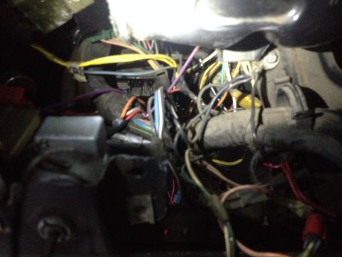 1979 Ford Bronco - A complex web of wires and connectors is visible in this close-up of a vehicle's interior wiring harness.