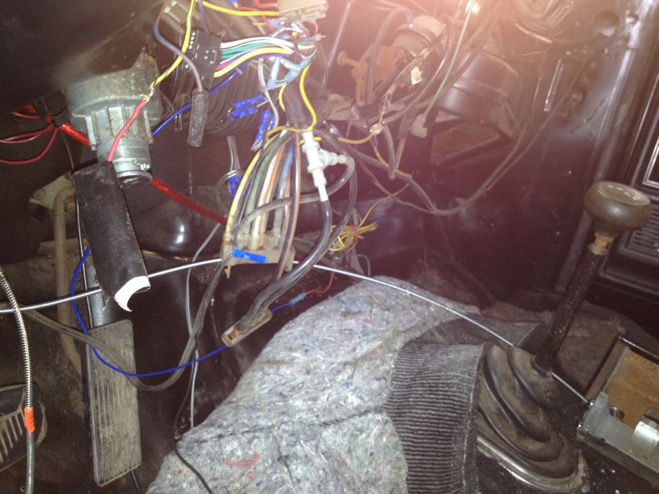 Close-up of tangled wires and pedals inside a vehicle