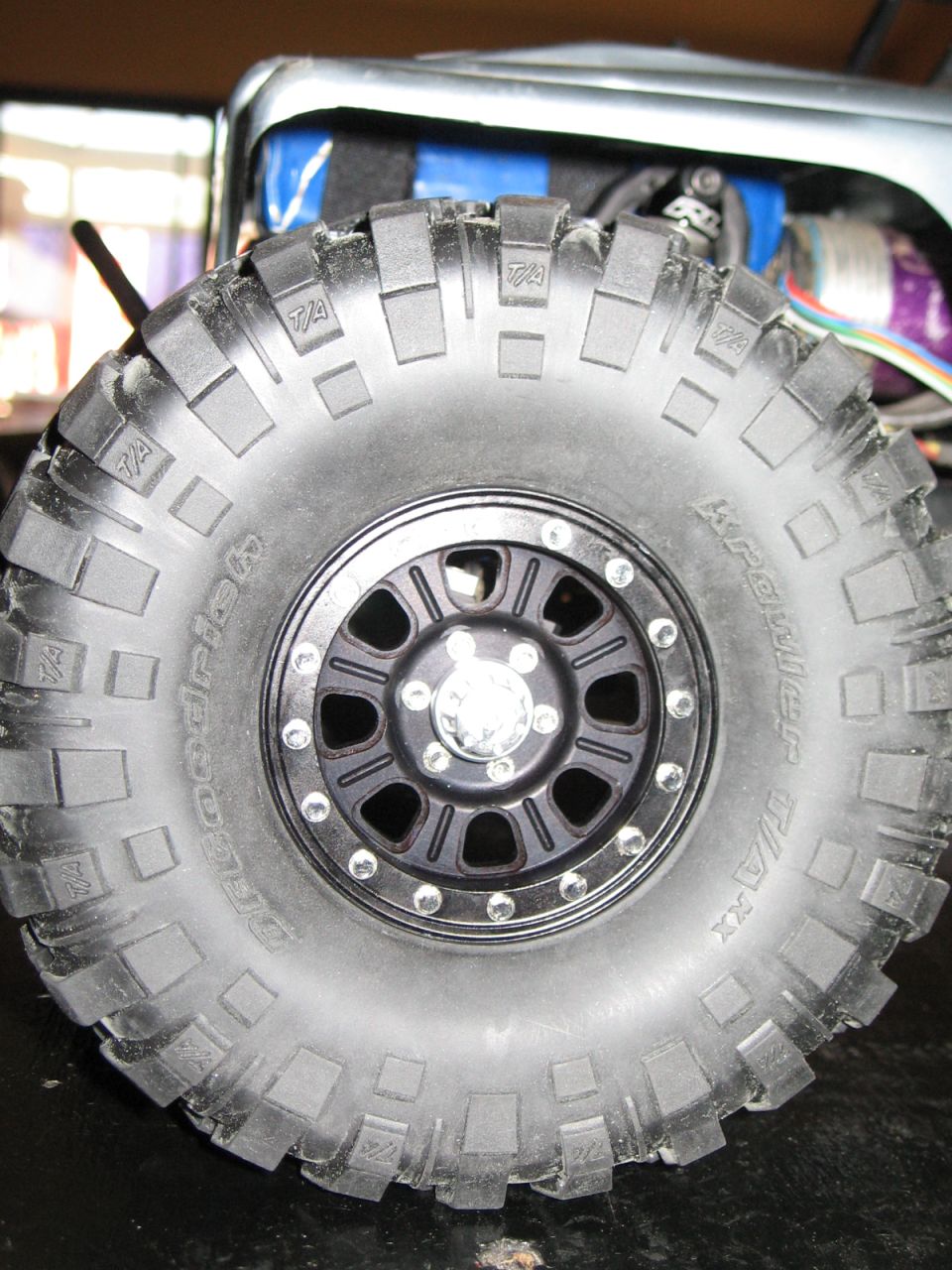 Close-up of a BFGoodrich tire on a black rim, part of an RC car
