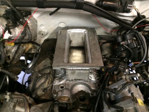 1996 Ford Bronco - Close-up view of a supercharger intake manifold installed in an engine bay.