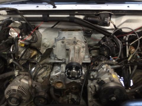 1996 Ford Bronco - Engine bay detail showing a supercharger mounted on the engine.