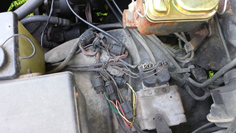 1984 Ford Bronco - Stupid wires, driver's side inner fender well.