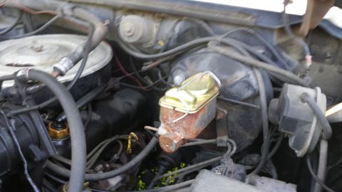 1984 Ford Bronco - Close-up view of a vehicle's engine compartment, showing mechanical components and wiring.
