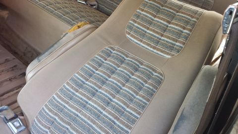 1984 Ford Bronco - Interior view of tan seats with distinctive striped fabric inserts, consistent with a 1984 Ford Bronco.