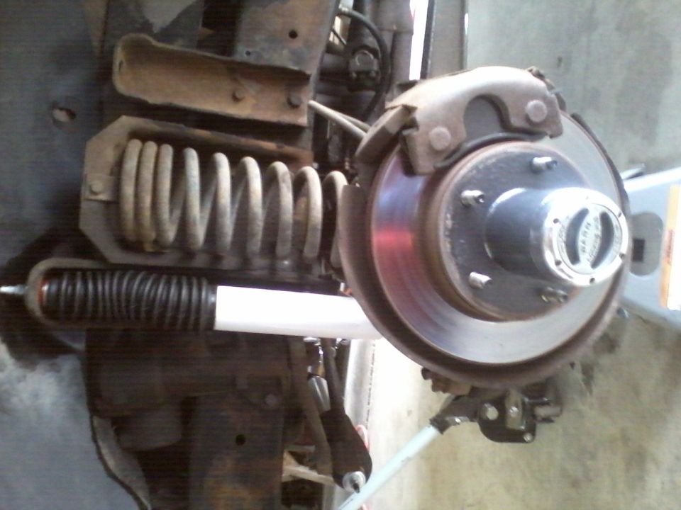 Front suspension coil spring and shock absorber with brake rotor and hub