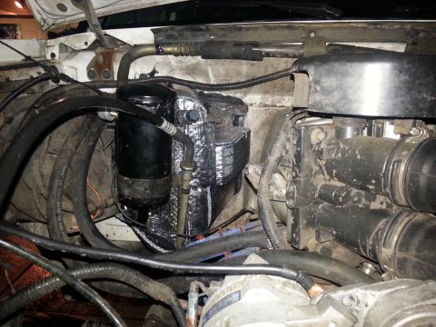 1992 Ford Bronco - Close-up view of engine bay components, including the AC accumulator and various hoses.
