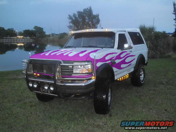 White 1994 Ford Bronco with purple flames and bull bar