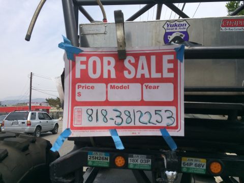 1968 Ford Mustang - A "FOR SALE" sign is attached to a large off-road vehicle, with another vehicle visible in the distance.