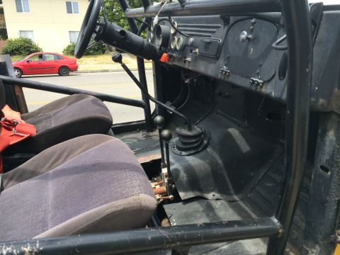 1968 Ford Mustang - The interior of a vehicle shows a roll cage, two seats, and a dashboard with various controls.