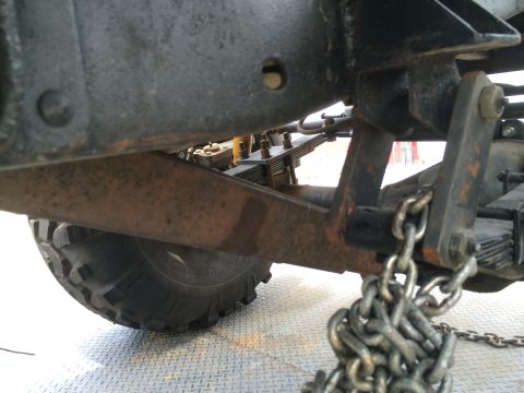 1968 Ford Mustang - Close-up view of the undercarriage of a vehicle, showing suspension and a chain.