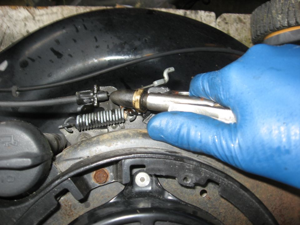 Close-up of cable repair with blue-gloved hand holding tool