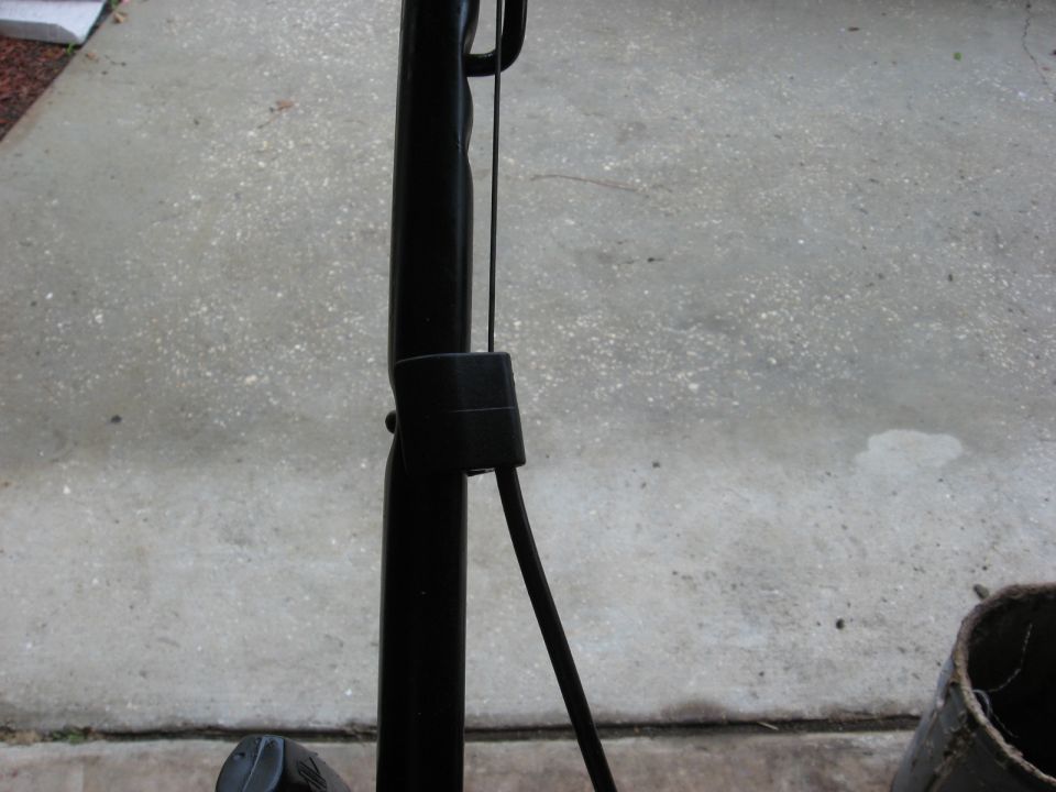 Close-up of black handlebar and a cable on what appears to be an ATV