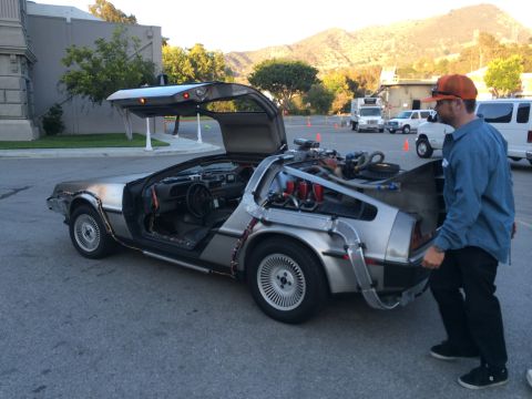 1968 Ford Mustang - A DeLorean DMC-12, famous for its gull-wing doors and unique design, is shown with its engine compartment accessible.