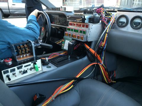 1968 Ford Mustang - The interior of a car modified with a complex time machine console, multiple digital displays and wiring.