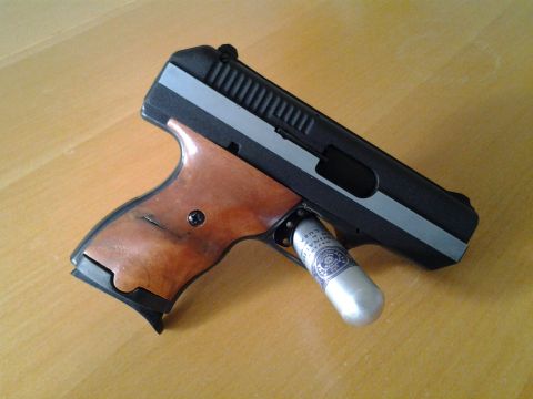 2003 Ford Crown Victoria - A handgun with wooden grips and a CO2 cartridge is shown on a wooden surface.