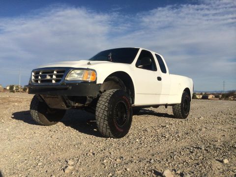 1988 Ford Bronco - This modified Ford F-150 pickup truck is equipped for off-road use with large tires and a custom bumper.