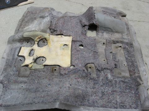 1994 Ford Bronco - Car carpet padding removed from vehicle, showing mounting points and underlayment.
