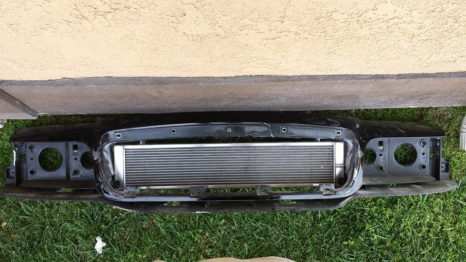 Front bumper support with mounted intercooler against a wall