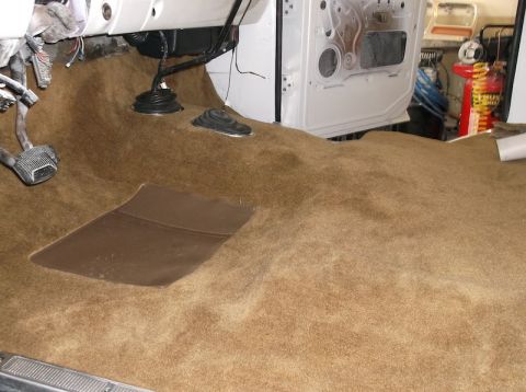 1979 Ford Bronco - New carpet installed on the interior floor of a vehicle, showing pedals and shifter boots.